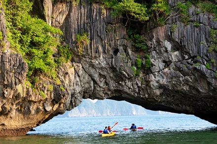 Du khách nước ngoài chèo kayak tại Vịnh Hạ Long. 