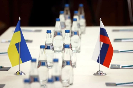 Quốc kỳ Nga và Ukraine trên bàn đàm phán trước khi hai phái đoàn bắt đầu đàm phán tại vùng Gomel, gần biên giới Belarus-Ukraine, ngày 28/2. (Ảnh: Reuters)