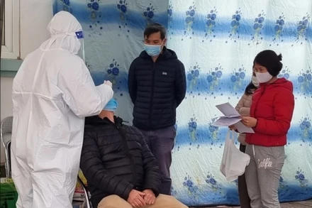 Người dân xếp hàng chờ xét nghiệm và lấy giấy xác nhận F0 tại trạm y tế phường tại Hà Nội. Ảnh: Mỹ Hà