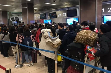 Bà con xếp hành làm thủ tục xuất cảnh tại sân bay thủ đô Bucharest, Romania. (Ảnh: Mạnh Hùng/TTXVN)