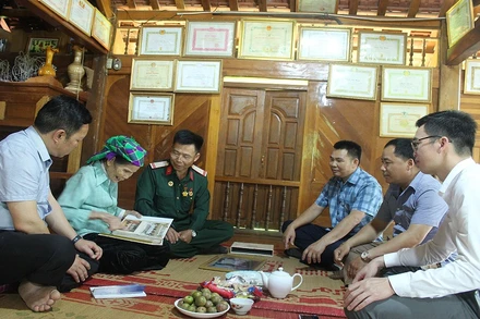 Bà Đinh Thị Uôn (bên trái ảnh cầm cuốn album ảnh) kể về thời điểm được gặp Bác Hồ năm 1959.