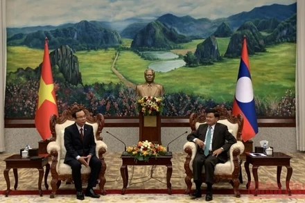 Tổng Bí thư, Chủ tịch nước Lào Thongloun Sisoulith (phải) tiếp đồng chí Nguyễn Văn Nên chiều 26/5. (Ảnh: Xuân Sơn)