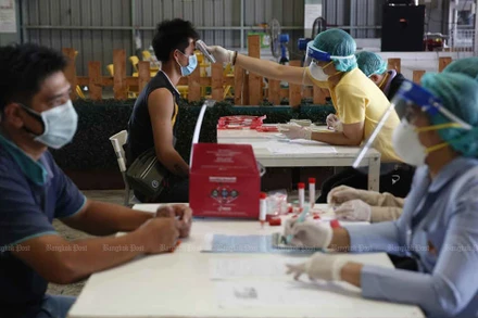 Nhân viên y tế đang lấy mẫu xét nghiệm Covid-19 cho lao động tại một khu chợ ở thủ đô Bangkok. (Ảnh: Bưu điện Bangkok)