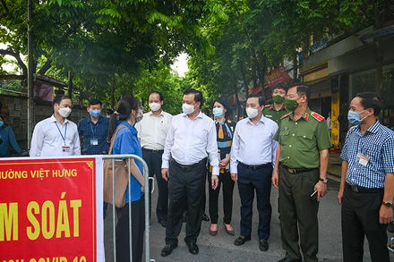 Bí thư Thành uỷ Đinh Tiến Dũng thăm hỏi, động viên lực lượng làm nhiệm vụ tại chốt kiểm soát dịch Covid-19 làng Lệ Mật, phường Việt Hưng (Long Biên). Ảnh: Duy Linh.