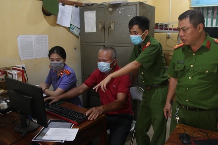 Đối tượng Vũ Văn Hà (áo đỏ) thực hiện lại các thao tác làm giả Giấy xét nghiệm Covid-19 trên máy tính cá nhân.