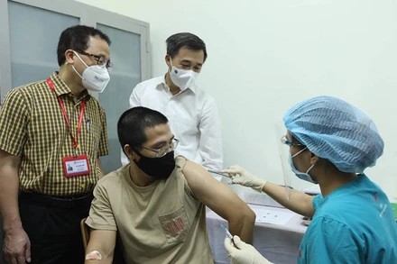 GS, TS Tạ Thành Văn và GS, TS Trần Văn Thuấn chứng kiến mũi tiêm thử nghiệm cho tình nguyện viên đầu tiên. (Ảnh: NGUYỄN QUYẾT)