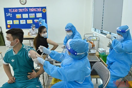 Người dân đi tiêm vaccine phòng Covid-19 tại quận Đống Đa, Hà Nội. (Ảnh: DUY LINH)