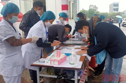 Thí sinh dự thi thực hiện khai báo y tế, đo thân nhiệt trước khi vào dự thi.