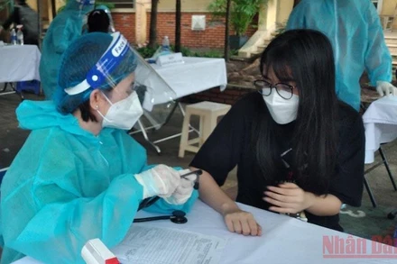 Khám sàng lọc cho học sinh trước khi tiêm vaccine phòng Covid-19 tại điểm tiêm Trường tiểu học thị trấn Củ Chi, huyện Củ Chi, TP Hồ Chí Minh.