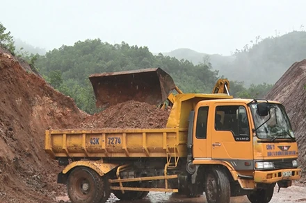 Huy động phương tiện khắc phục sạt lở đất lấp đường.