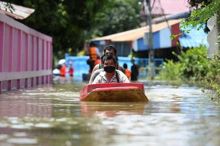 Người dân đi thuyền qua một con đường bị ngập nặng ở tỉnh Lopburi, Thái Lan. (Ảnh: Reuters)
