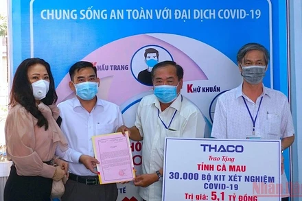 Đại diện MTTQ tỉnh Cà Mau tiếp nhận 30.000 kít test nhanh từ đơn vị tài trợ. (Ảnh: HỮU TÙNG)