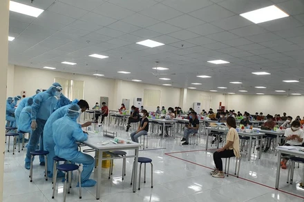 Lực lượng y tế lấy mẫu xét nghiệm Covid-19 cho công nhân tại KCN Vân Trung. (Ảnh: ĐẶNG GIANG)