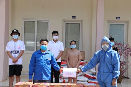 Đồng chí Trần Đại Thắng (phải) trao hỗ trợ cho đại diện Đoàn lưu học sinh Việt Nam tại Trường Đại học Quốc gia Lào, chiều 4-5. 