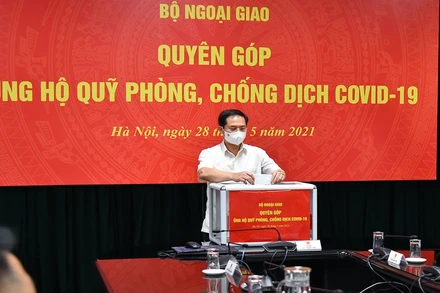 Bộ trưởng Ngoại giao Bùi Thanh Sơn quyên góp ủng hộ công tác phòng, chống dịch Covid-19. (Ảnh: Bộ Ngoại giao)