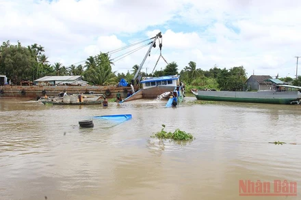 Dùng cần cẩu chuyên dùng để trục vớt xà lan bị chìm.