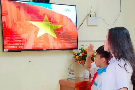 Học sinh chào cờ qua sóng truyền hình trong ngày khai giảng năm học mới.