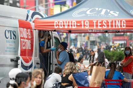 Nhân viên y tế lấy mẫu xét nghiệm COVID-19 tại một điểm xét nghiệm lưu động trên quảng trường Thời Đại ở New York, Mỹ, ngày 20/7.