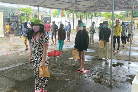 Người dân xếp hàng vào nhận gạo.