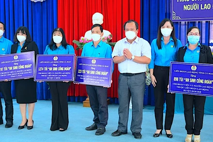 Phó Chủ tịch UBND tỉnh Cà Mau (áo trắng) trao tượng trưng túi “An sinh Công đoàn” cho đại diện các tổ chức công đoàn trong tỉnh.