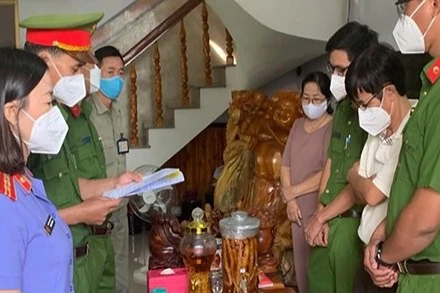 Cơ quan Cảnh sát điều tra Công an đọc lệnh khởi tố, bắt tạm giam ông Đoàn Thế Nam (áo trắng bên phải).