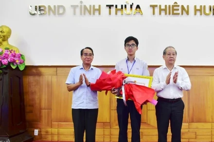 Phó Bí thư Thường trực Tỉnh ủy Bùi Thanh Hà và Chủ tịch UBND tỉnh Phan Ngọc Thọ trao tặng Bằng khen của UBND tỉnh cho em Hồ Việt Đức.