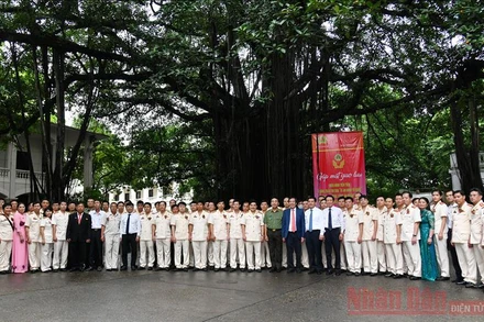 Các đại biểu dự chương trình chụp ảnh lưu niệm dưới gốc đa Báo Nhân Dân.