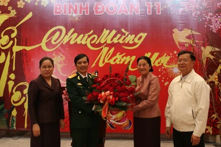 Chủ tịch Quốc hội Lào Pany Yathotou (thứ hai từ phải sang) tặng hoa chúc mừng năm mới cán bộ, chiến sĩ Binh đoàn 11, chiều 11-2.