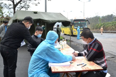 Cán bộ y tế thực hiện khai báo y tế đối với người ra vào địa bàn, ở chốt kiểm soát y tế Xuân Giao (Bảo Thắng - Lào Cai).