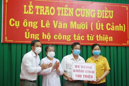 Đại diện gia đình cụ Lê Văn Mười trao tiền cúng điếu tới các tổ chức, cá nhân làm công tác an sinh xã hội trên địa bàn tỉnh Vĩnh Long.