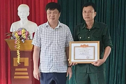 Phó Chủ tịch UBND huyện Thanh Chương Lê Đình Thanh trao giấy khen cho ông Nguyễn Hữu Hiền. (Ảnh: Báo Nghệ An)