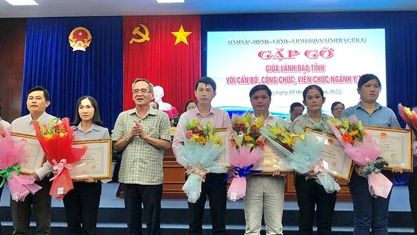 Đồng chí Bí thư Tỉnh ủy Bạc Liêu Lữ Văn Hùng tặng bằng khen và hoa cho những thầy thuốc xuất sắc trong tỉnh. (Ảnh: TRỌNG DUY)