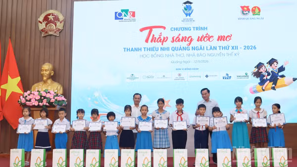 Lãnh đạo tỉnh Quảng Ngãi và đại diện Quỹ học bổng Thắp sáng ước mơ trao học bổng cho học sinh nghèo, vượt khó học giỏi. (Ảnh: HIỂN CỪ)