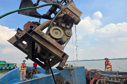 Trạm Cảnh sát giao thông đường thủy Sa Đéc thuộc Phòng Cảnh sát giao thông Công an tỉnh cho chủ phương tiện tự nguyện tháo gỡ thiết bị bơm hút cát, sỏi. (Ảnh: Công an Đồng Tháp)