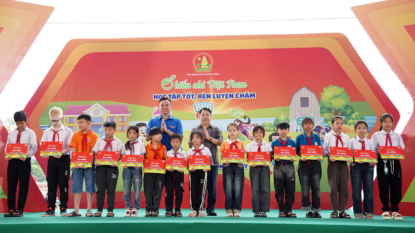 Phó Chủ tịch Hội đồng Đội Trung ương, Giám đốc Trung tâm Hỗ trợ và Phát triển thiếu nhi Việt Nam Lê Anh Quân (bên trái, hàng sau) cùng đại diện Ban tổ chức Ngày hội trao học bổng tặng thiếu nhi hoàn cảnh khó khăn.