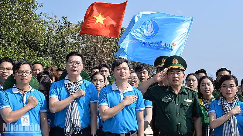 Các đại biểu thực hiện nghi lễ chào cờ chủ quyền tại Cột mốc số 0 ngã ba biên giới Việt Nam - Lào - Trung Quốc. 