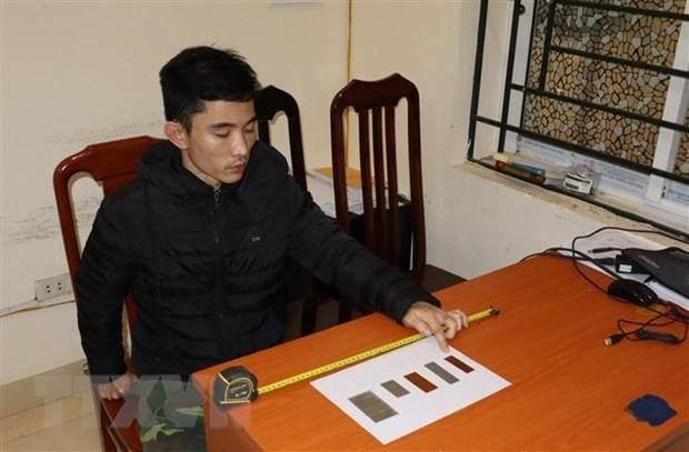 Đối tượng Nguyễn Trung Huyên tại cơ quan Công an. (Ảnh: TTXVN)