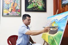 Cao Thanh Nam với bức tranh đang sáng tác.
