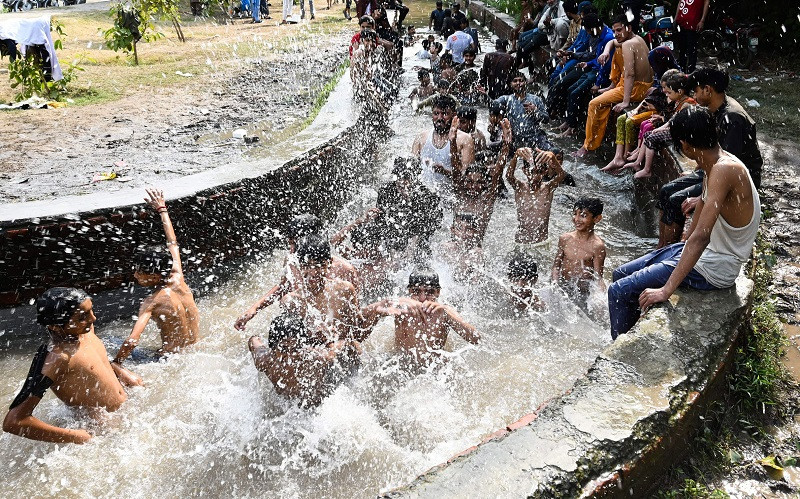 Người dân Pakistan giải nhiệt trong kênh nước ở Lahore, ngày 29/4/2022. (Ảnh: Getty Images) Ấn Độ: Nắng nóng kỷ lục khiến ít nhất 25 người thiệt mạng -0