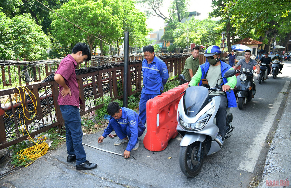 Sáng 22/6, nhân viên Công ty Cổ phần đường sắt Hải Hà - đơn vị quản lý, duy tu cầu Long Biên đã tiến hành đo đạc để lắp cột chắn ngăn ô-tô và xe ba gác tải nặng đi lên cầu. Lắp rào chắn bảo vệ cầu Long Biên -0