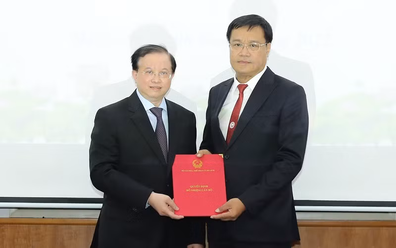 Thứ trưởng Văn hóa, Thể thao và Du lịch Tạ Quang Đông trao quyết định bổ nhiệm cho ông Đặng Hà Việt (bên phải). (Nguồn: Toquoc.vn)