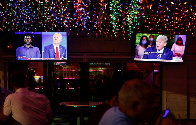 Người dân theo dõi chương trình tại một nhà hàng ở Florida. (Ảnh: Reuters) Hai ứng viên Tổng thống Mỹ trong phiên hỏi - đáp riêng rẽ với cử tri -0