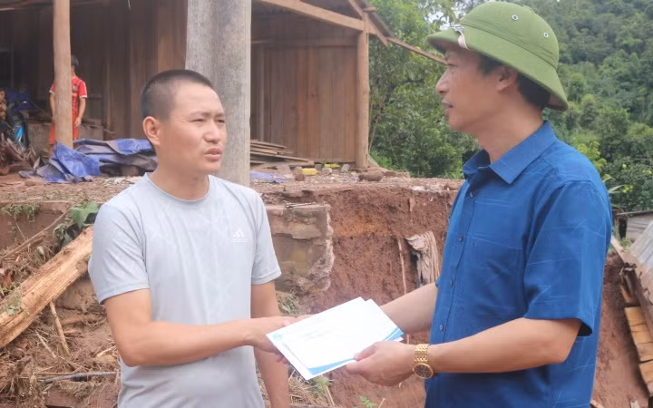 Đồng chí Lê Khánh Hòa, Bí thư Huyện ủy Nậm Pồ, trao hỗ trợ cho gia đình bị lũ cuốn trôi nhà.