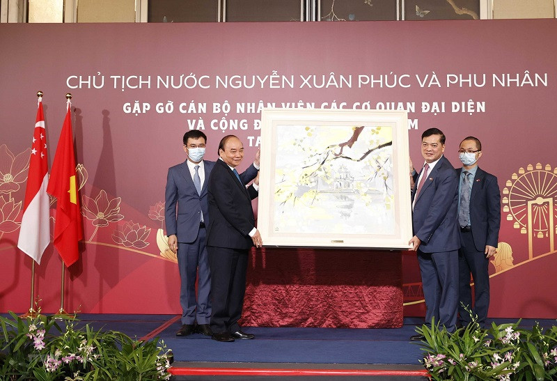 Chủ tịch nước Nguyễn Xuân Phúc tặng quà lưu niệm cho Đại sứ quán Việt Nam tại Singapore. (Ảnh: TTXVN) Chủ tịch nước Nguyễn Xuân Phúc gặp mặt cán bộ Đại sứ quán và cộng đồng người Việt tại Singapore -0