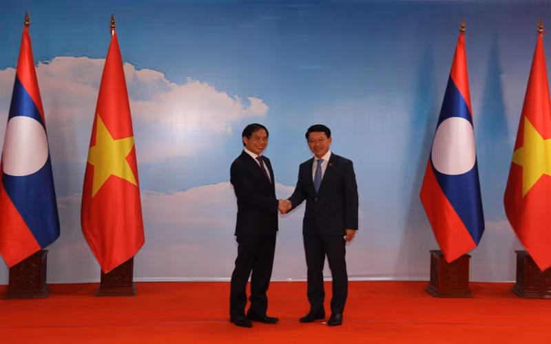 Bộ trưởng Ngoại giao Lào Saleumxay Kommasith (phải) tiếp đón Bộ trưởng Ngoại giao Việt Nam Bùi Thanh Sơn.