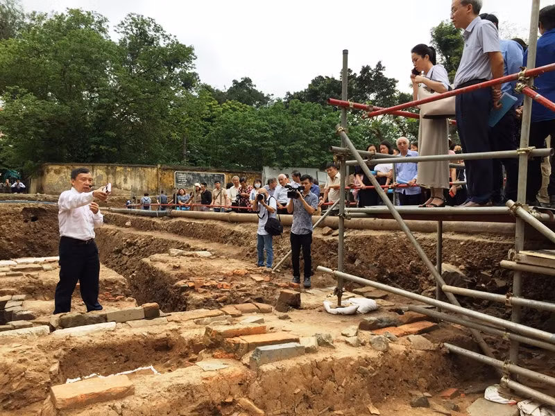 Các nhà khoa học khảo sát hiện trường hố khai quật khảo cổ. 