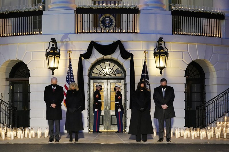 Tổng thống Biden và đệ nhất phu nhân Jill Biden, cùng Phó Tổng thống Kamala Harris và phu quân Doug Emhoff (từ trái sang) mặc niệm hơn 500 nghìn người tử vong do Covid-19 trong ánh sáng của 500 ngọn nến được thắp bên ngoài Nhà trắng. Chiều 22-2 (theo giờ Mỹ), Nhà trắng và Đồi Capitol cũng treo cờ rủ để tưởng nhớ những người đã khuất. (Ảnh: AP) US -0