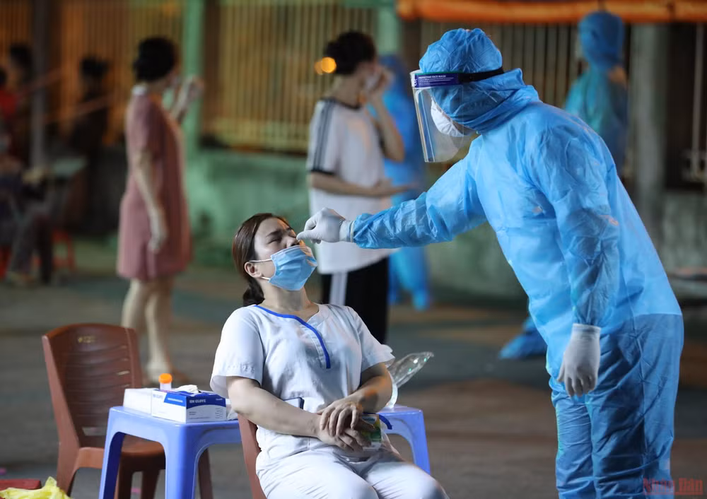 Lấy mẫu xét nghiệm Covid-19 cho người dân. (Ảnh: DUY LINH)