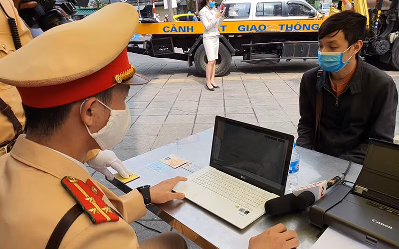 Cán bộ Ðội Cảnh sát giao thông số 2 (Công an TP Hà Nội) tiến hành xử phạt "online" đối với người vi phạm thông qua cơ sở dữ liệu quốc gia về dân cư. 