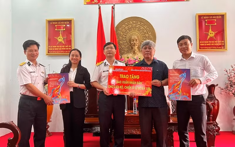 Đại diện Cơ quan Thường trực Báo Nhân Dân tại TP Hồ Chí Minh và đại diện Tổng Công ty Điện lực Miền Nam trao tặng báo Xuân Nhân Dân 2022 cho cán bộ, chiến sĩ Lữ đoàn 125 Hải quân.